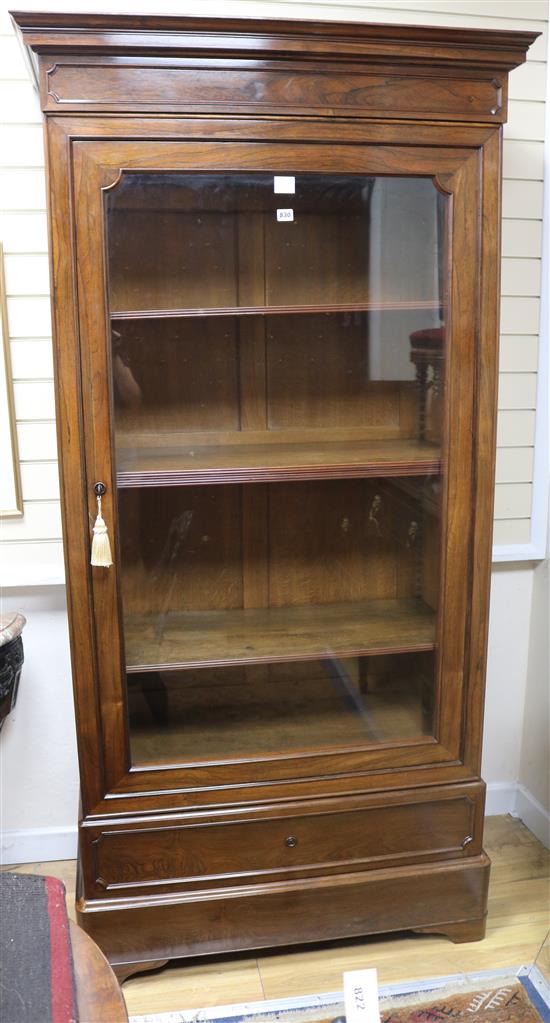 A mid 19th century French rosewood bookcase, enclosed by a glazed door, W.103cm